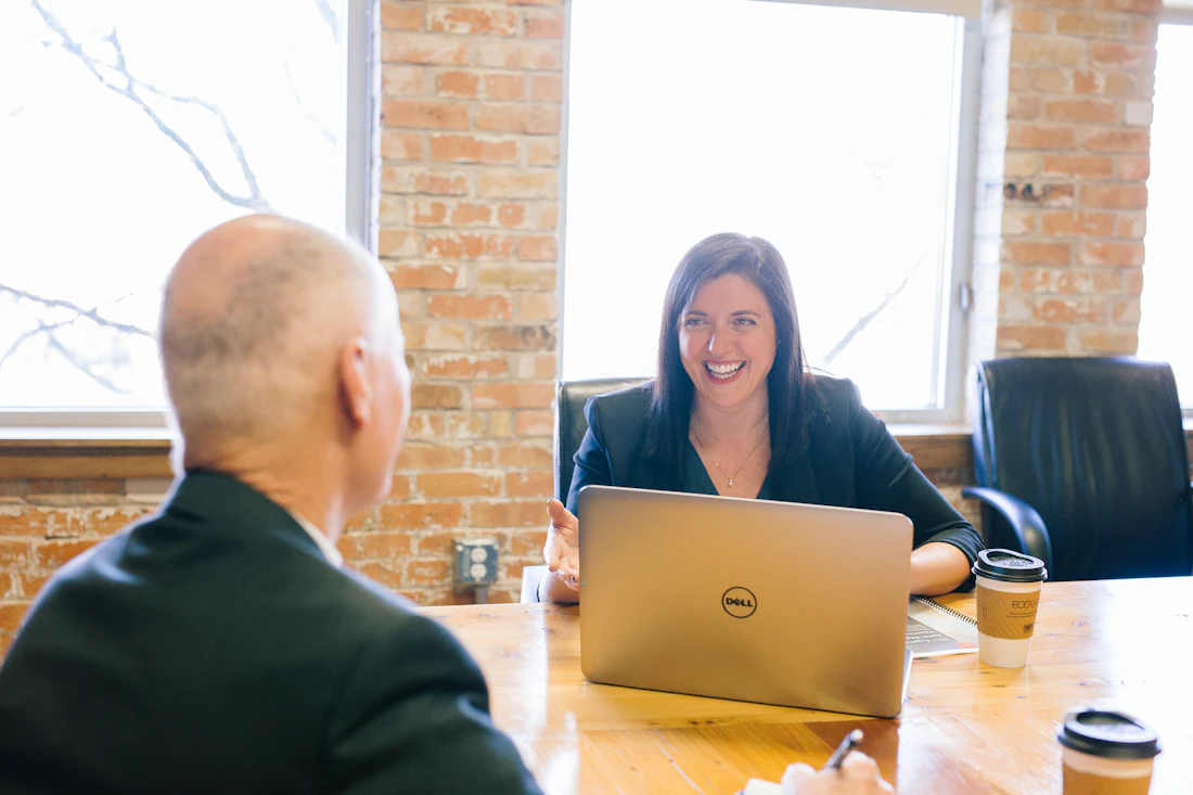 Two colleagues in a friendly business conversation